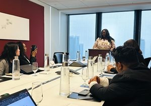 OBA Past-President Charlene Theodore speaks to Career Accelerator participants from a podium in a meeting room