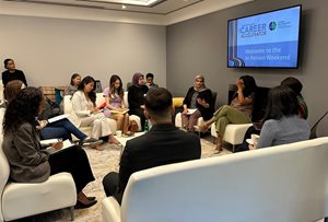 group of Career Accelerators participates in roundtable discussion with faculty member in OBA member lounge