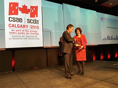 Jill Mayer presented with award by CEO of CSAE Michael Andrerson