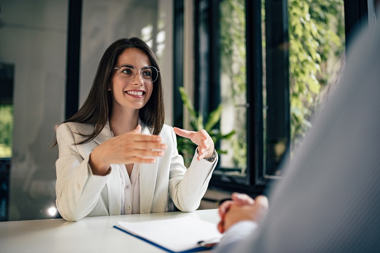 female lawyer at desk explaining services to male client