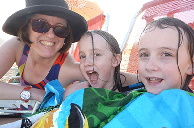 Woman with two young girls at a beach