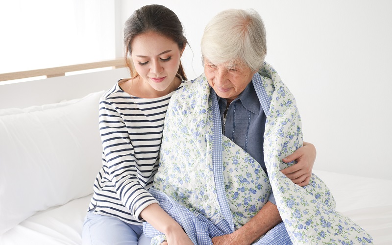 Young woman assists older lady