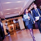 Man and woman walking down hallway in front of Gowlings