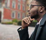 Black man staring off contemplatively