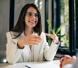 female lawyer at desk explaining services to male client