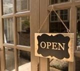 Wooden doors with a Open sign on them