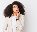 Young Black professional woman with long hair striking a ponderous pose