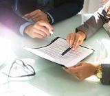 a woman and man review a legislative document