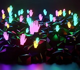 A graphic of many brightly coloured hands in a group raised as if volunteer