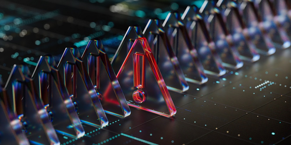 series of clear triangle tiles atop a computer chip, with one red tile containing an exclamation mark standing out