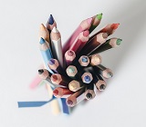 coloured pencils in a jar with a ribbon around it, like a bouquet