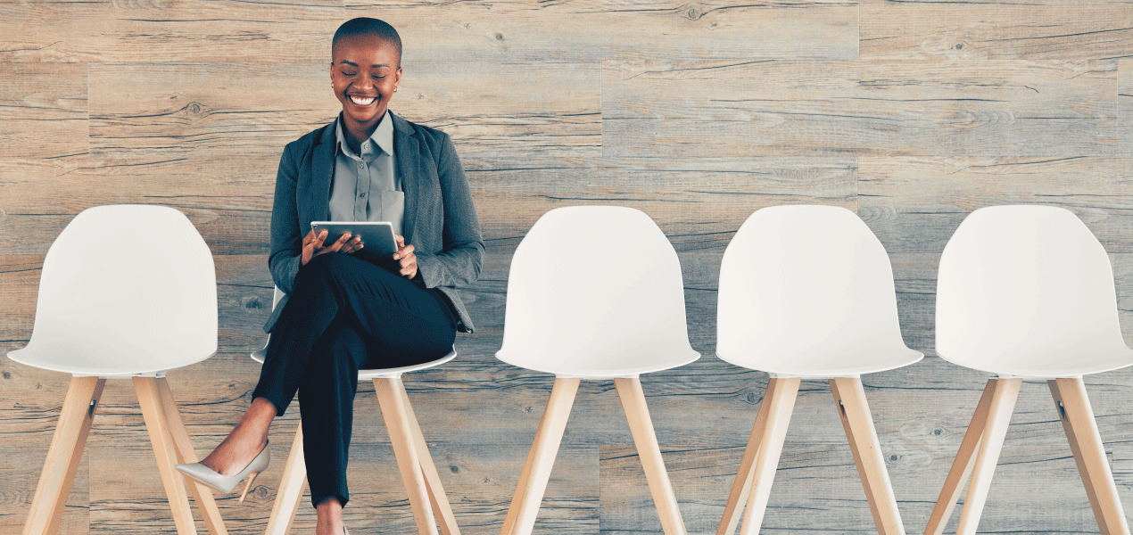 Woman sitting infront of a laptop taking notes