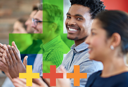 Diverse group of professionals clapping and smiling during an event or presentation, with colorful g