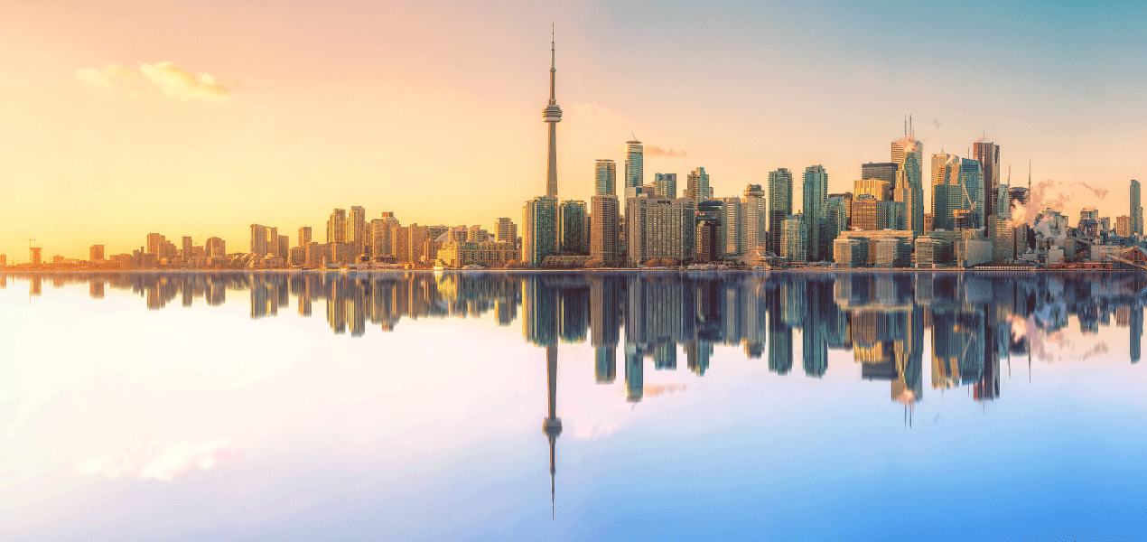 Business traveler walking through a modern hotel lobby with a suitcase, featuring stylish yellow chairs and natural light from large windows.