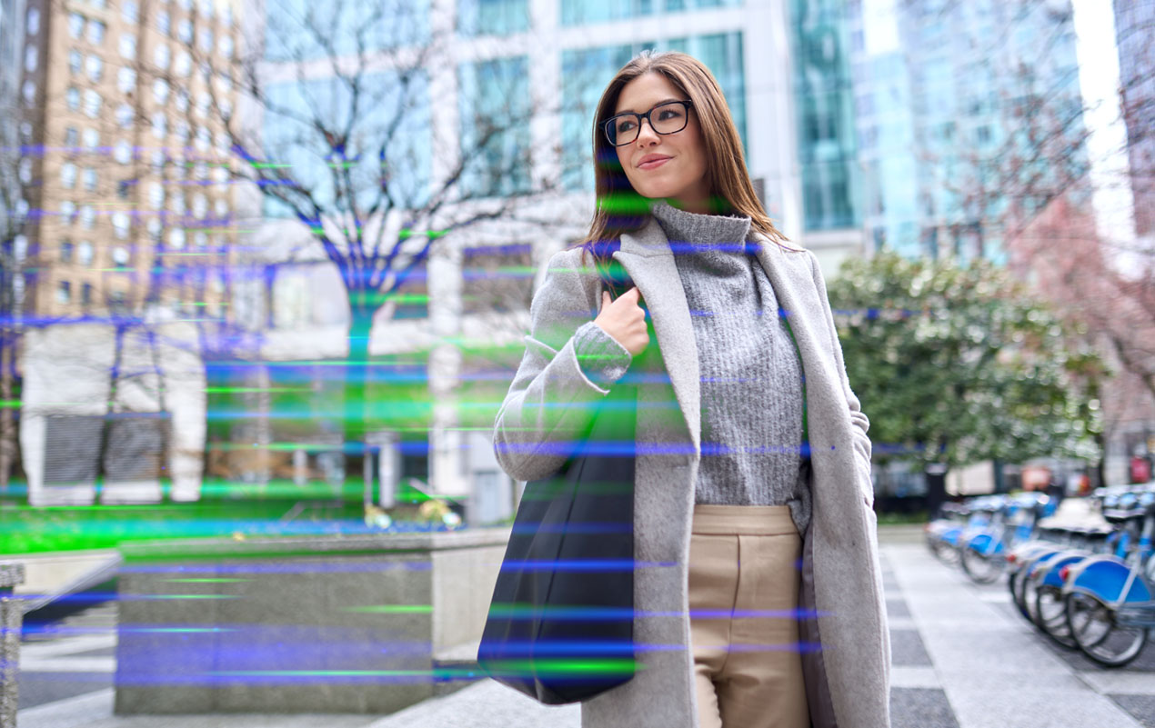 Professional woman in business attire standing outdoors in an urban setting with modern office buildings, symbolizing career growth, leadership, and professional development.