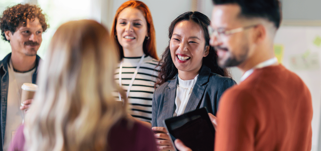 Group of diverse professionals networking and sharing ideas at a business event.